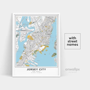 May include: Framed map print of Jersey City, New Jersey, with street names. The map features a detailed layout of the city with blue water areas and yellow and green land areas. The text "JERSEY CITY" is at the bottom.