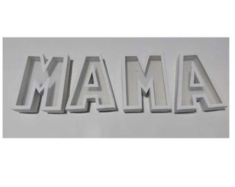 May include: White 3D letters spelling "MAMA". The letters are block-style with a shadow effect, creating depth. The letters are placed on a white surface, and the overall design is clean and modern.
