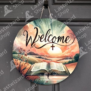 May include: A round wooden sign with a sunset scene, a field of grass, and an open book with a cross. The sign says "Welcome" in a decorative font.