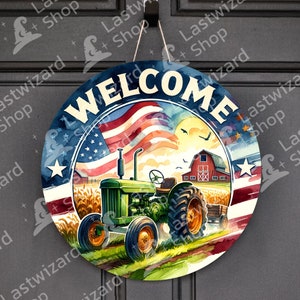 May include: A round wooden sign with the word "WELCOME" in a white, red, and blue font. The sign features a green tractor driving through a field of wheat with a red barn in the background. An American flag is waving in the wind behind the tractor.