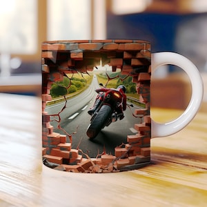 May include: A white ceramic mug with a 3D design of a red motorcycle speeding through a brick wall. The motorcycle is on a road with green trees and a blue sky in the background.