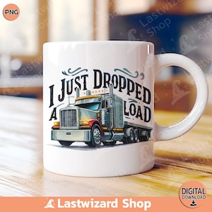 May include: White ceramic mug featuring a semi-truck graphic with the text "I JUST DROPPED A LOAD." The truck is gray, red, and yellow. The mug has a curved handle and is suitable for hot or cold beverages.