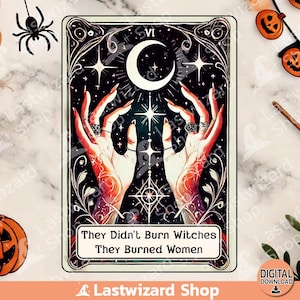 May include: A tarot card with a black background and a crescent moon. Two hands reach up towards a bright star. The card reads "They Didn't Burn Witches They Burned Women".