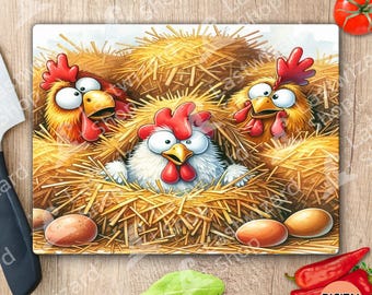 Peut inclure: Une planche à découper rectangulaire en verre présentant une illustration colorée de trois poulets de dessin animé aux yeux écarquillés et aux crêtes rouges nichés dans de la paille jaune. Trois œufs bruns lisses sont au premier plan.