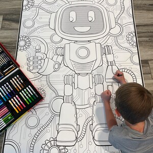 May include: A black and white coloring page featuring a robot with a friendly face and gears. A child is coloring the page with colored pencils.
