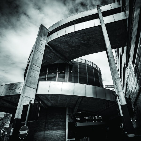 Black and White Brutalist Architecture, Manchester Shudehill Car Park Spiral Exit with Dramatic Sky