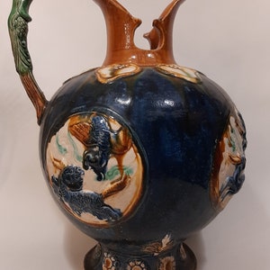 Antique can of ceramics with hand-painted decorations of animals
