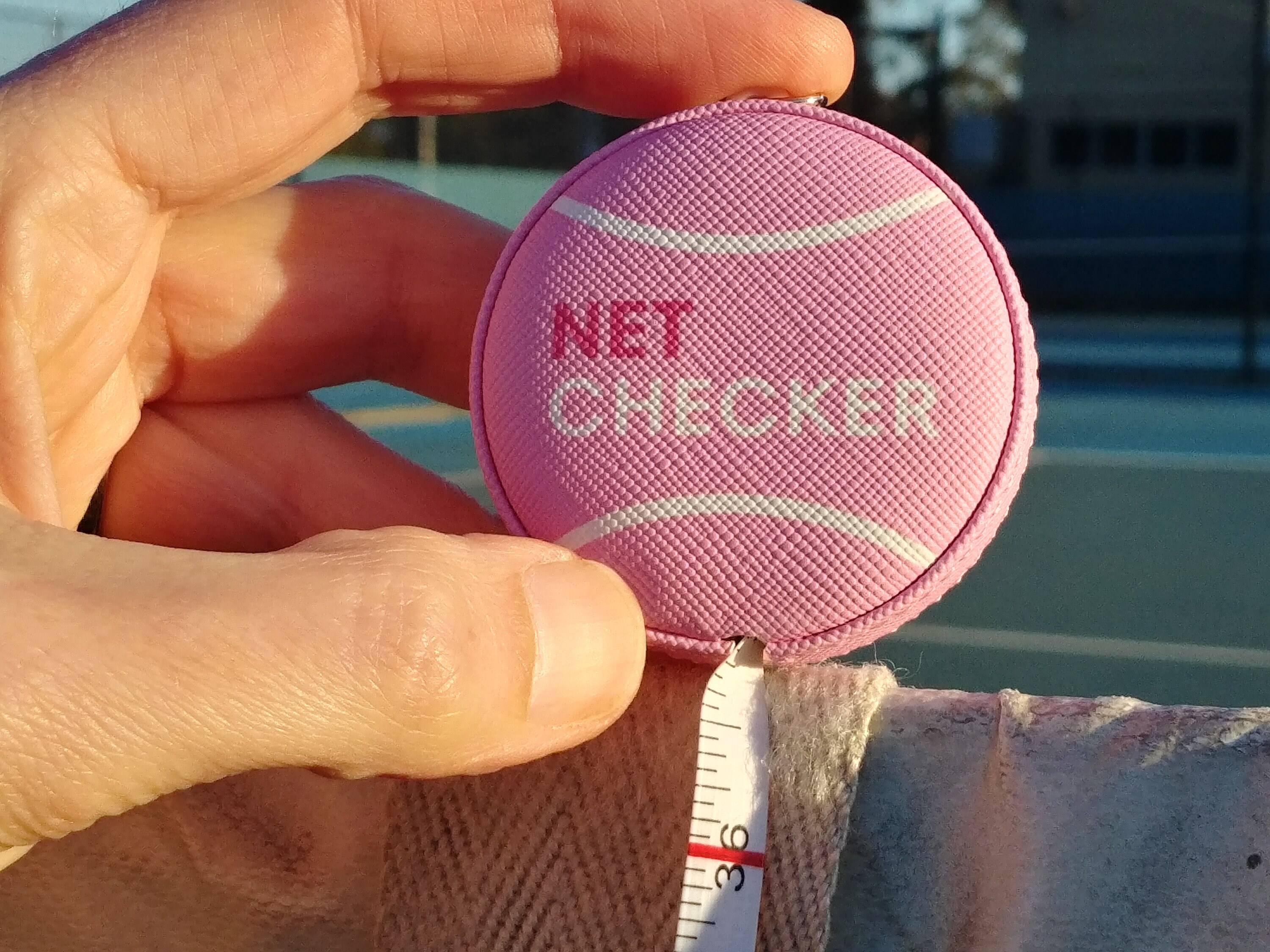 Tennis Net Height Measuring Device With a Tennis Ball Design