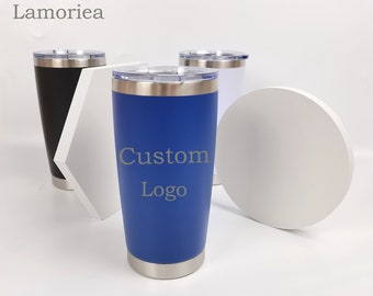 May include: Three stainless steel tumblers with lids. The tumbler on the left is black, the tumbler in the center is blue and says "Custom Logo", and the tumbler on the right is white.