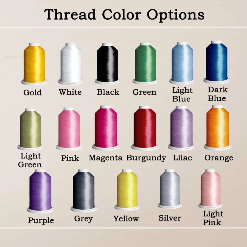May include: Image showing a selection of thread color options. The image displays spools of thread in various colors, including gold, white, black, green, light blue, dark blue, light green, pink, magenta, burgundy, lilac, orange, purple, grey, yellow, silver, and light pink.