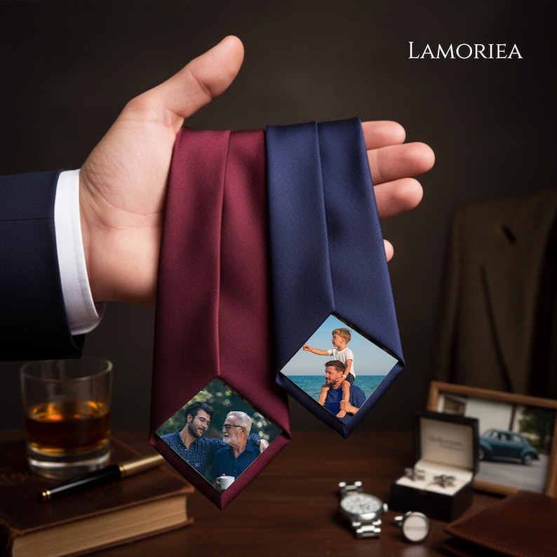 May include: Two neckties in solid burgundy and navy blue, each featuring a diamond-shaped photo insert at the bottom. The burgundy tie displays a photo of two men, while the navy blue tie shows a photo of a child sitting on a man's shoulders.