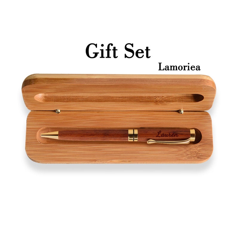 May include: A wooden gift set with a bamboo box and a wooden pen with a gold trim. The pen is engraved with the name "Lauren".