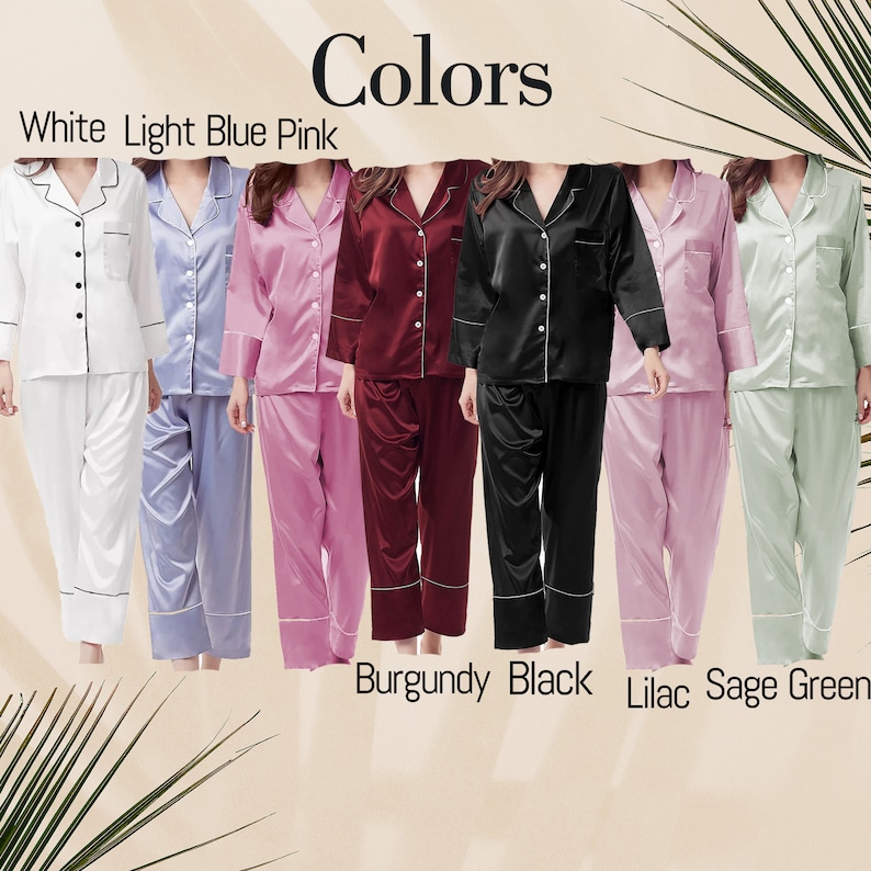 May include: A collection of seven button-down pajama sets with long sleeves and matching trousers, displayed in white, light blue, pink, burgundy, black, lilac, and sage green. Each set features a notched collar and contrasting piping detail.