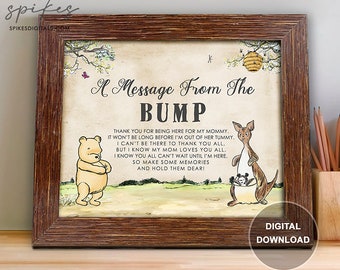 May include: A Winnie the Pooh and Kanga themed baby shower sign with the text "A Message From The BUMP" and a message thanking guests for being there for the mommy-to-be. The sign is framed in a rustic brown frame.