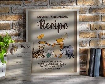 May include: A framed print with the text "Favorite Childhood Recipe" and illustrations of Winnie the Pooh characters. A recipe card is in front of the frame. The image is set against a brick wall.