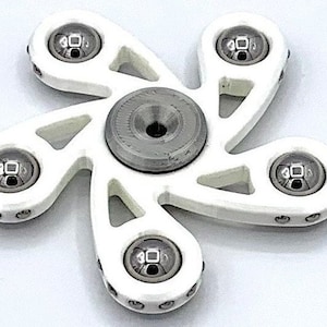 May include: White plastic fidget spinner with five points and five silver ball bearings. The spinner has a silver metal center.
