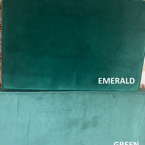 May include: Two green velvet cushions, one labelled "EMERALD" and the other "GREEN".