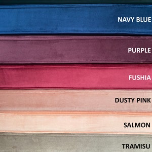 May include: A collection of eight fabric swatches in various shades of blue, purple, pink, and brown. The swatches are labelled with the following names: Dark Cyan, Navy Blue, Purple, Fushia, Dusty Pink, Salmon, Tramisu, and Ocean Blue.