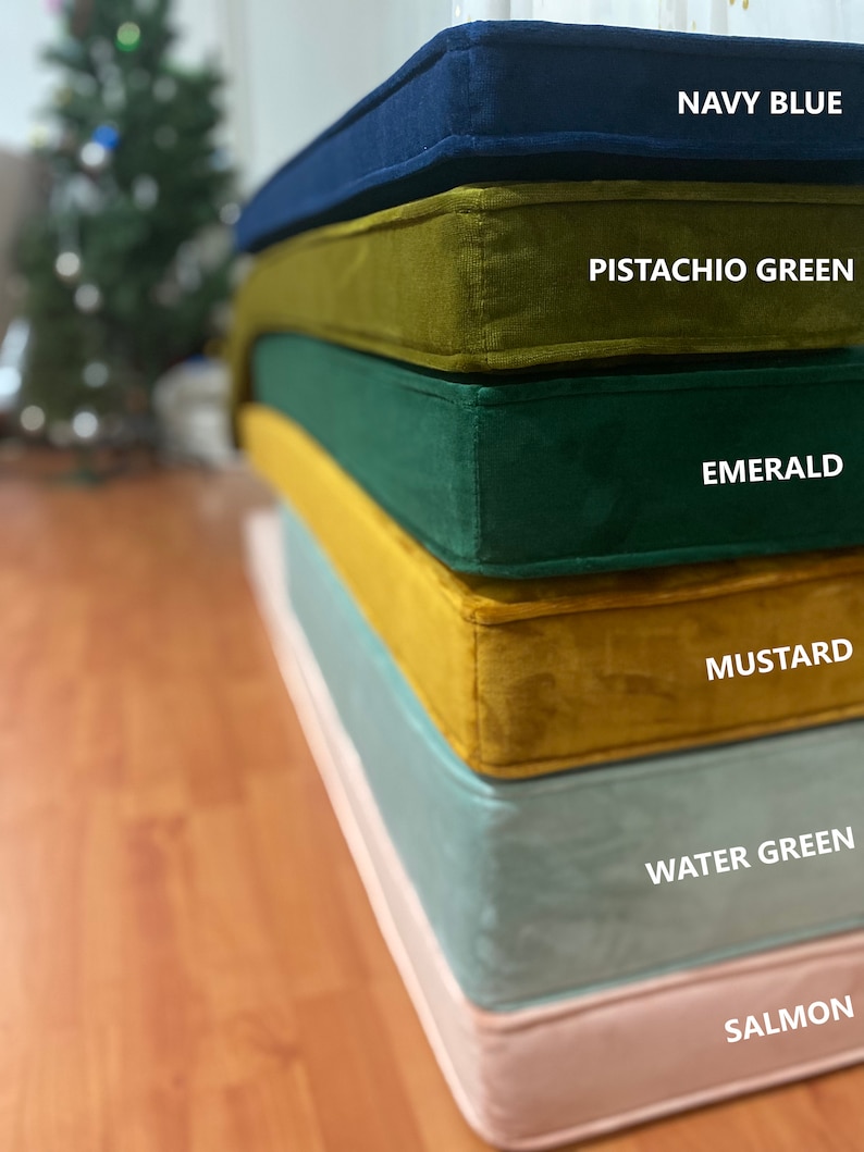 May include: Stack of six velvet cushions in different colours: navy blue, pistachio green, emerald green, mustard yellow, water green, and salmon pink.
