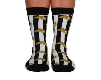 May include: A pair of black and white striped socks with a banana pattern. The socks are made of a soft, comfortable material and are perfect for everyday wear.