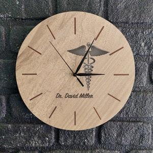 May include: A wooden clock with a medical symbol and the name "Dr. David Miller" engraved on the face.