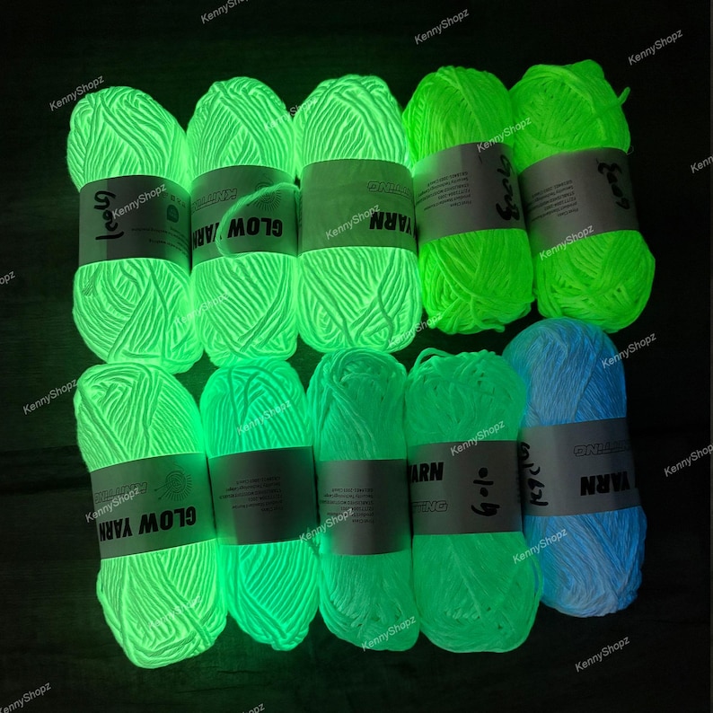 May include: Ten skeins of glow-in-the-dark yarn arranged in two rows. Each skein features a white paper label with the text GLOW YARN printed on it. The yarn emits a bright neon green light, except for one skein on the bottom right which glows blue.