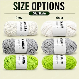 May include: Six skeins of yarn in white, gray, and lime green, each weighing 50g. The yarn is categorized by thickness with 2mm options on the left and 4mm options on the right. Each skein features a white paper band with the text YARN KNITTING.