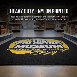 a large, colorful mat with the text "THE COLORING MUSEUM" printed on it, located in a store or similar indoor setting.