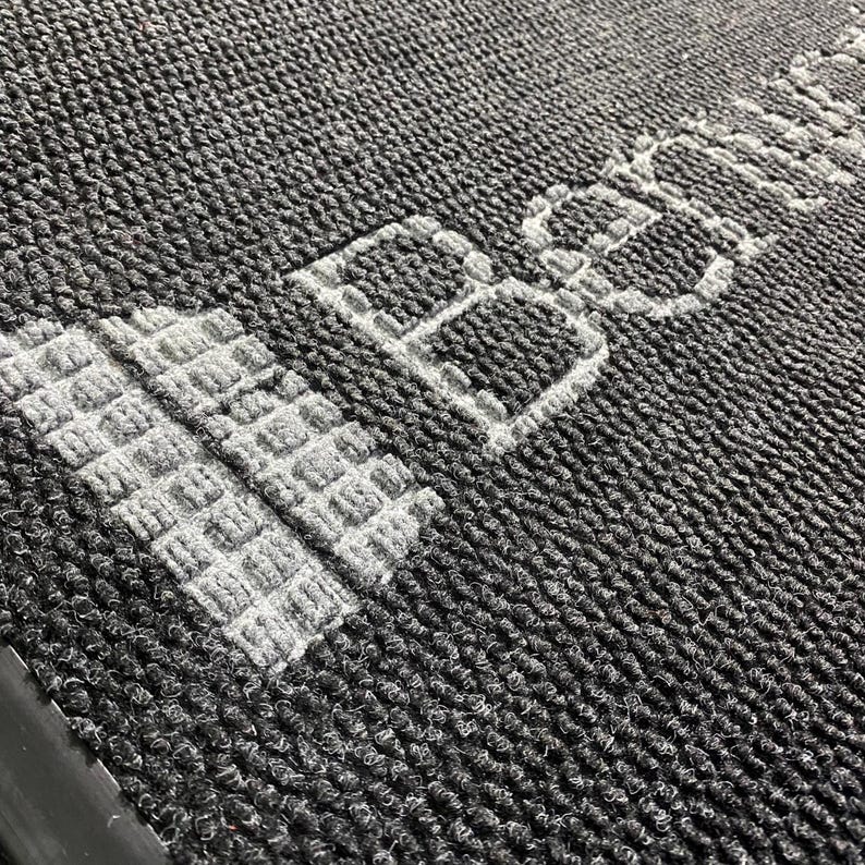 a close up of a rug with a building on it