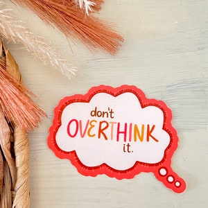 May include: A pink and orange speech bubble sticker with the text "don't overthink it."