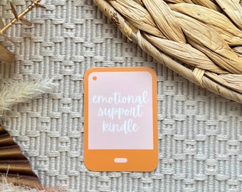 May include: Orange and pink phone-shaped card with the text "emotional support kindle" in white.