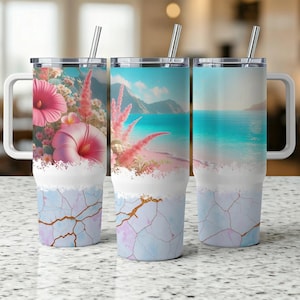 May include: Three stainless steel travel tumblers with handles and straws. Each tumbler features a different design: one with pink hibiscus flowers, one with a beach scene, and one with a seascape. The bottom half has a blue and gold marble pattern.