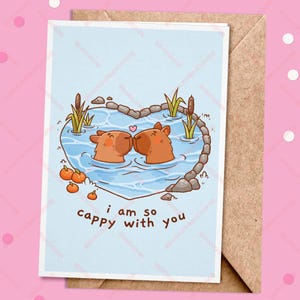 I Am So Cappy With You Greeting Card, Illustrated Cute Cappybara Couple Swimming in a Pond Valentines Day Greeting Card, Blank A6 Postcard