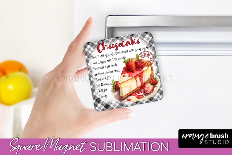 May include: Square sublimation magnet with a black and white checkered background. The magnet features a slice of cheesecake with strawberries and a red sauce drizzle. The text on the magnet reads "Cheesecake" and includes a recipe for cheesecake.