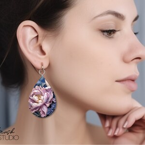 May include: A pair of teardrop-shaped earrings with a floral design. The earrings are made of polymer clay and feature a pink peony flower with blue and green leaves. The earrings are a beautiful and unique piece of jewelry.