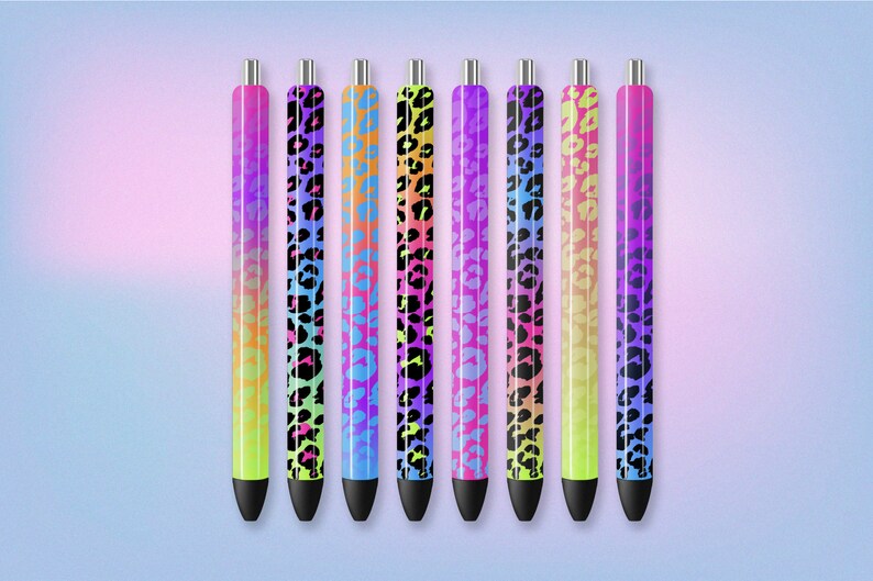 May include: Seven colorful pens with a leopard print design. The pens have a black ink tip and a silver clip. The pens are arranged in a row from left to right.