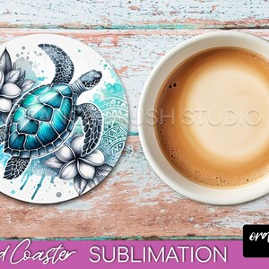 May include: A round coaster with a sublimation design of a blue and green sea turtle swimming in a watercolor background with white flowers. The coaster is on a wooden surface.