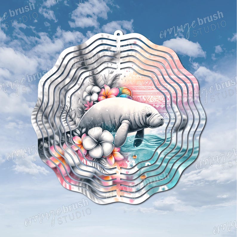 May include: A decorative metal wind spinner featuring a manatee swimming in water, surrounded by flowers. The design is split, with one side in grayscale and the other in vibrant colors. The background is a blue sky with clouds.