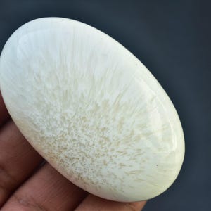 May include: A set of three ceramic mugs with a speckled, cream-colored glaze. Each mug features a different hand-painted floral design in shades of blue, green, and yellow. The mugs have a simple, rounded shape and a comfortable handle.