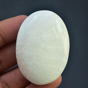 May include: A white ceramic mug with a black handle and the text "But First, Coffee" in a bold, black font. The mug is set against a neutral background, highlighting its simple design.