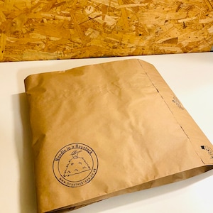 May include: A brown paper bag with a logo that says "Needle in a Haystack" and a website address: www.haystackies.co.uk