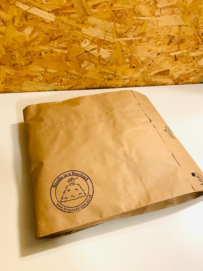 May include: A brown paper bag with a logo that says "Needle in a Haystack" and a website address: www.haystackies.co.uk