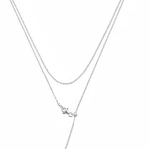 May include: A silver-toned double-layered chain necklace featuring a delicate cable link design. The necklace includes a lobster claw clasp and an adjustable sliding bead mechanism that allows for length customization, finished with a small metal bead.