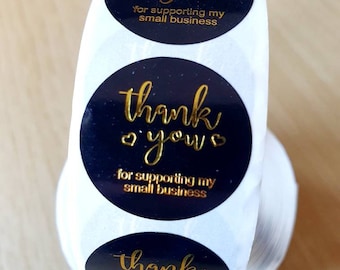 May include: Roll of round black and gold thank you stickers with the text "thank you" and "for supporting my small business".