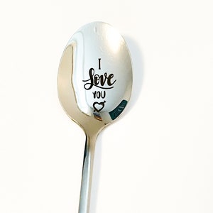 May include: A silver spoon with the words "I love you" and a heart engraved on the bowl.