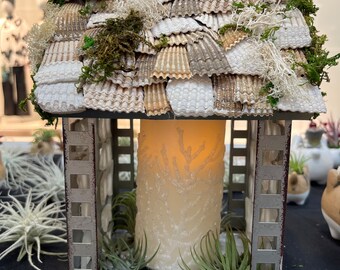 seaside lit up house with sea shells and sea glass