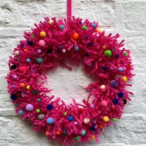 Gorgeous sustainable, eco friendly pink wool and felt pom pom wreath/ ring/ wall/door hanging size 12”