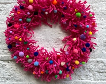 Gorgeous sustainable bright pink wool wreath,ring,door,wall hanging with felt rainbow pom-poms size 16”