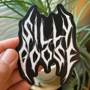 May include: Black and white sticker with the text "SILLY GOOSE" in a stylized, metal font.