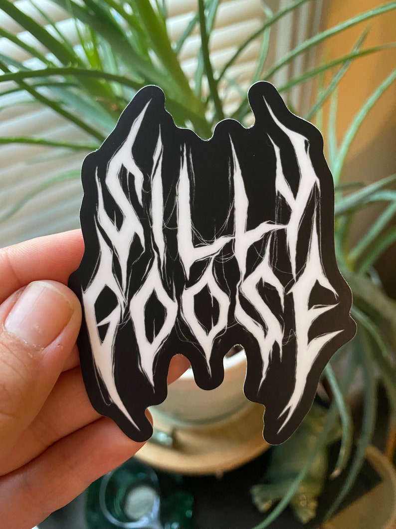 May include: Black and white sticker with the text "SILLY GOOSE" in a stylized, metal font.